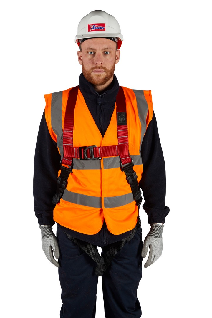 A man wearing a high-visability jacket, hard hat, and safety harness